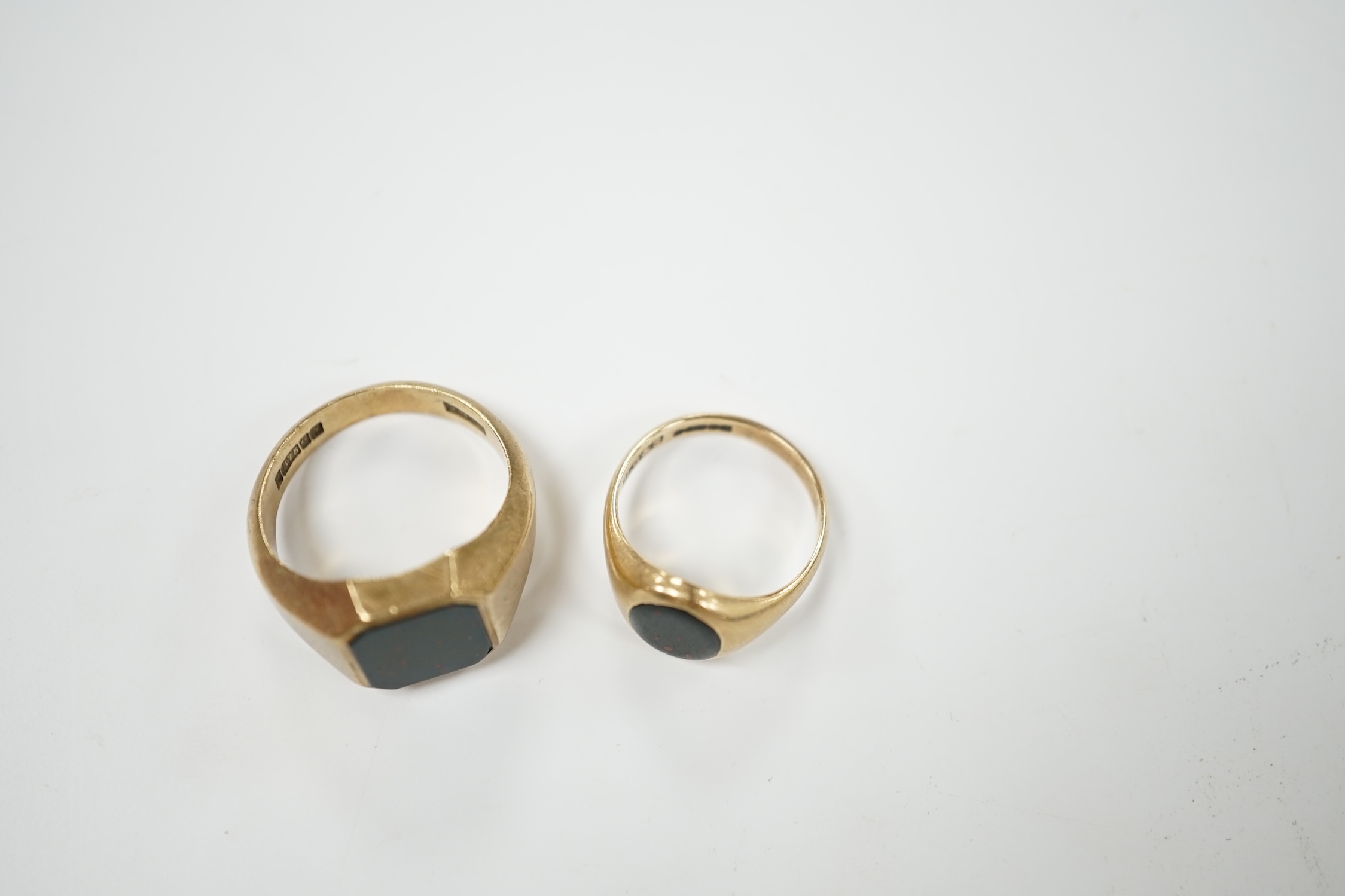 Two 9ct gold and bloodstone set signet rings, largest size Q, gross weight 11.5 grams. Condition - poor to fair